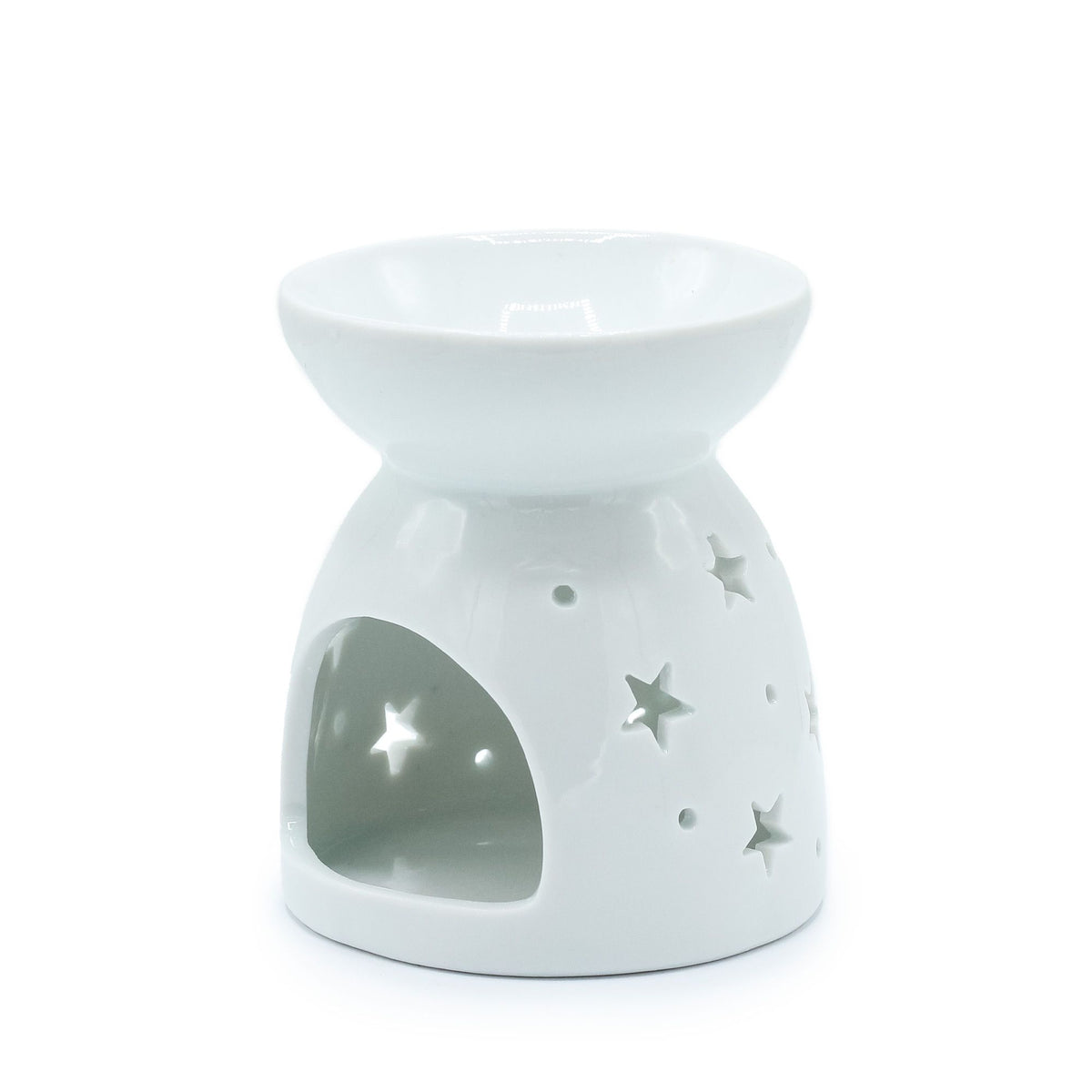 White ceramic oil burner with star designs on a white background