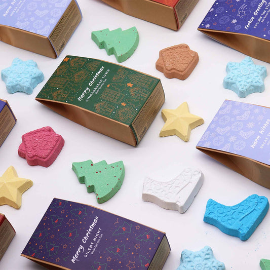 Colorful Christmas-themed bath bombs with decorative boxes