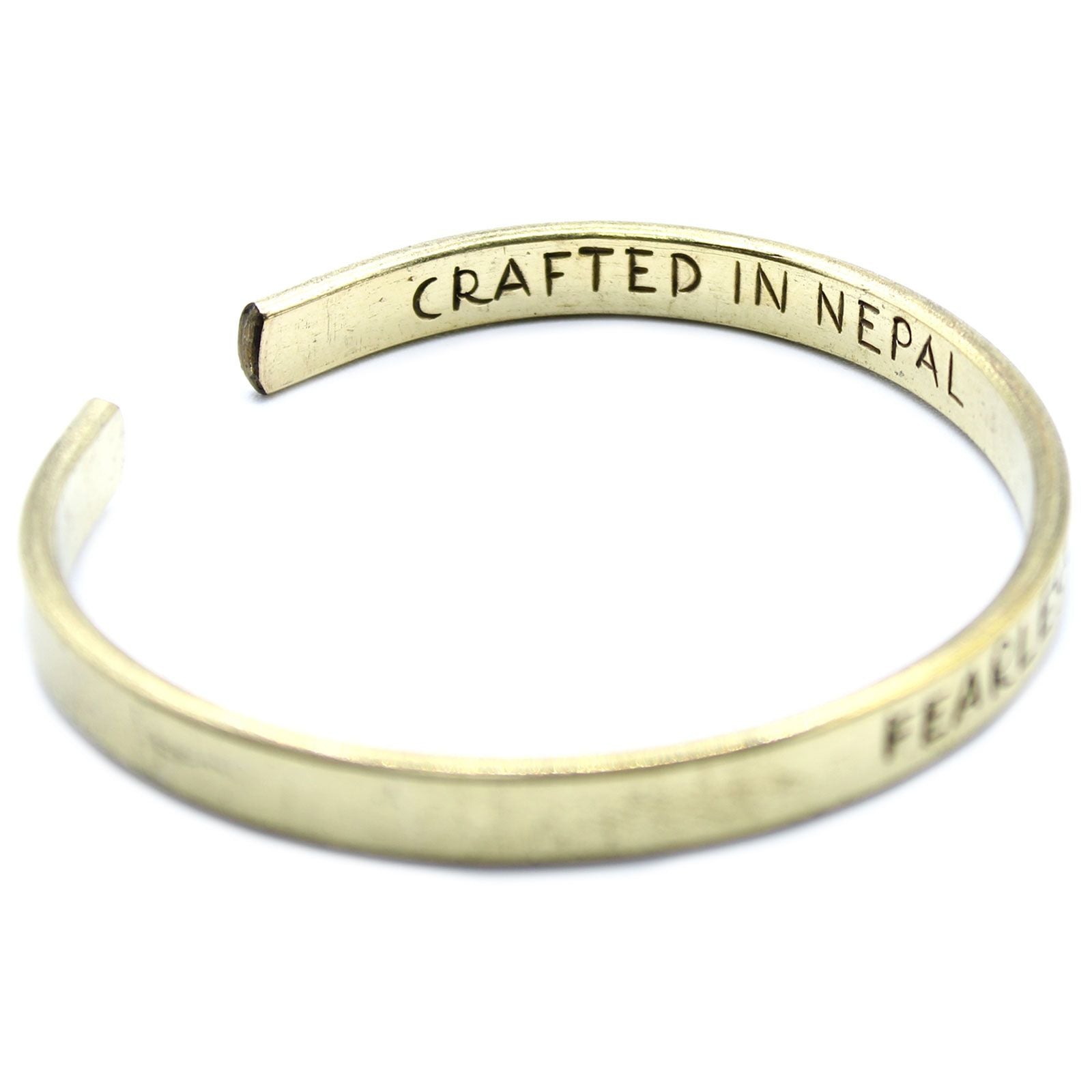Gold bracelet with 'Crafted in Nepal' engraving on a white background