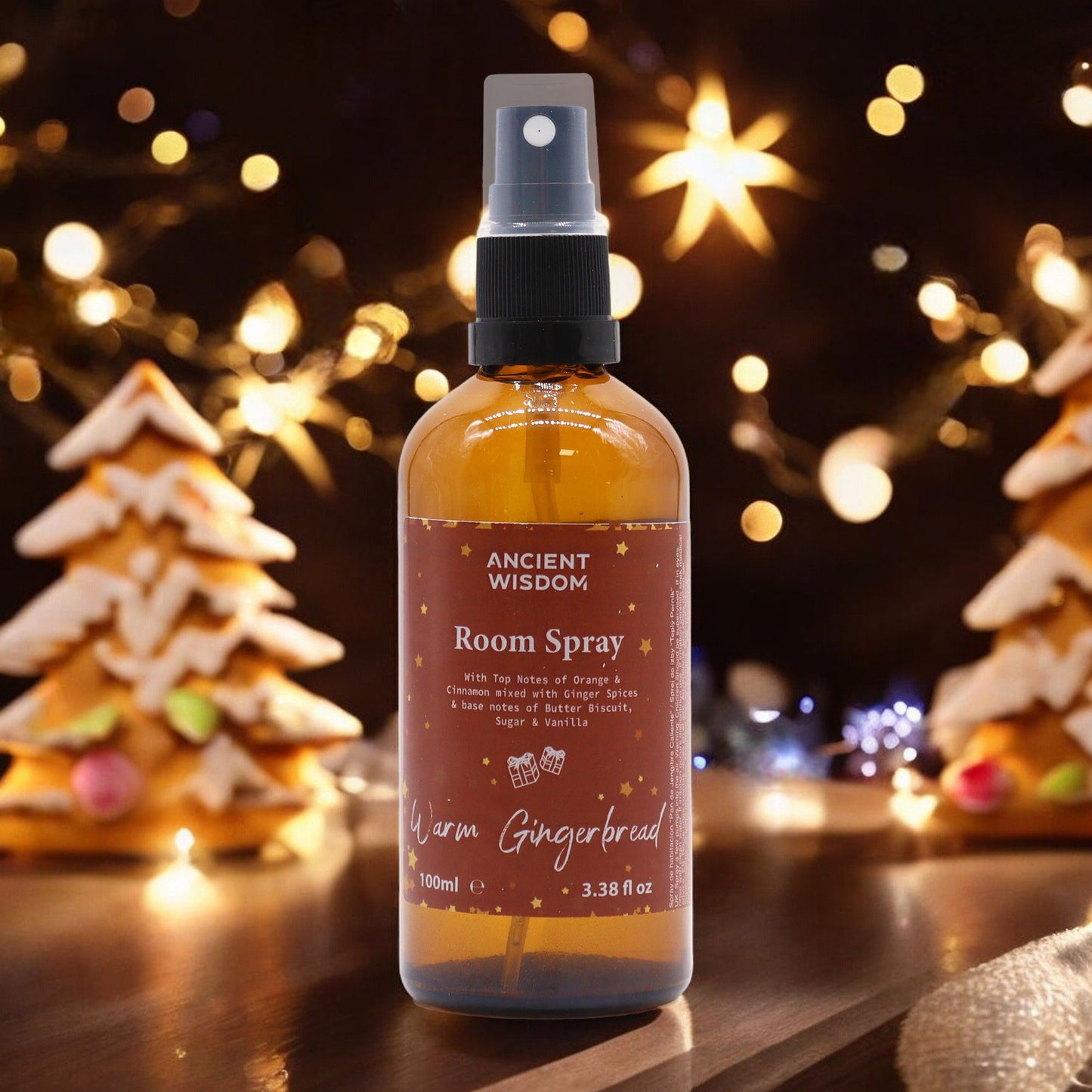 100ml Warm Gingerbread room spray bottle with gingerbread men, cinnamon sticks and orange slices on cosy Christmas kitchen background