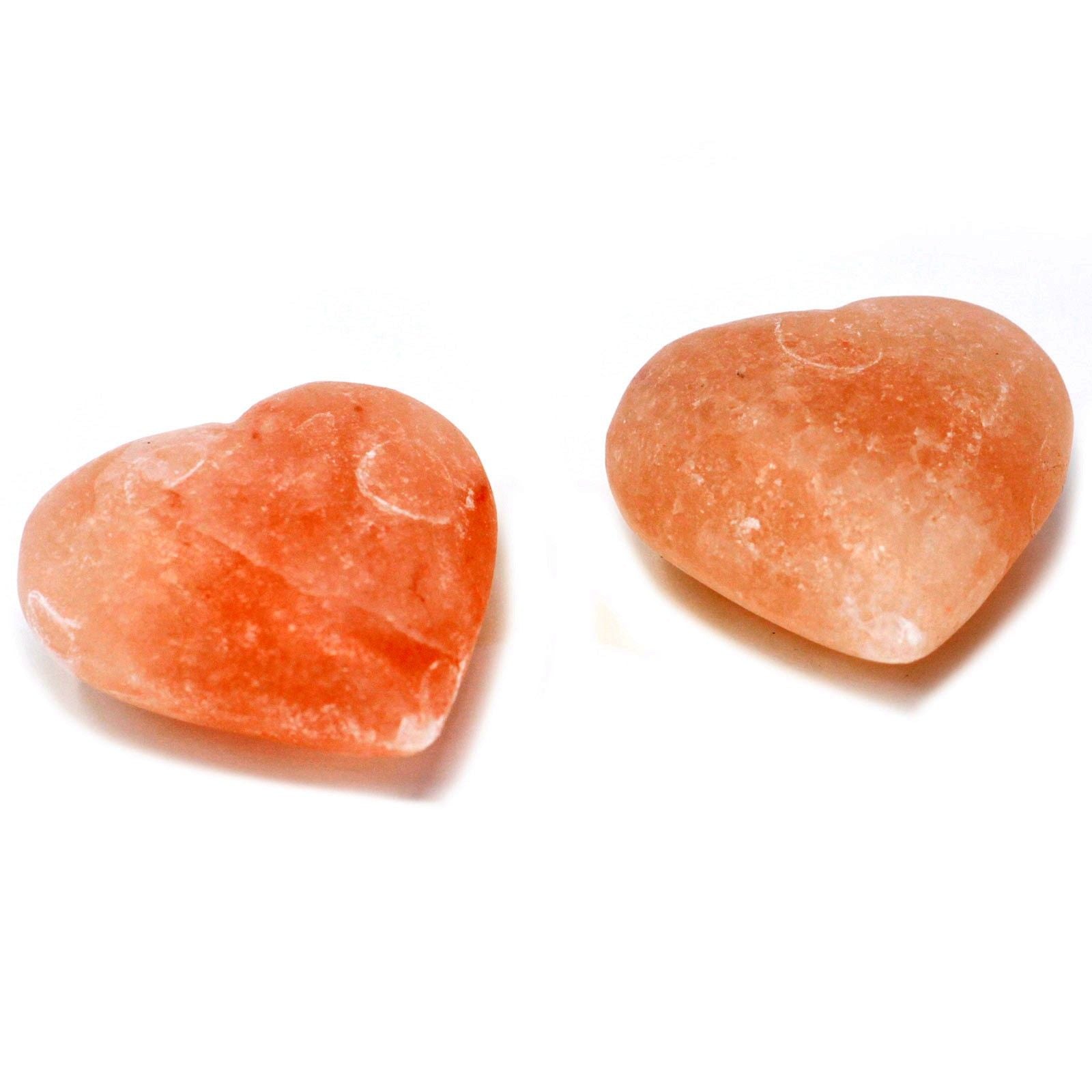 Two orange himalayan heart deodorant stones on a white background