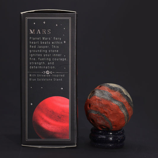 40mm deep red Jasper Mars sphere dramatically lit on sparkling goldstone ring stand against dark cosmic background with fiery glow