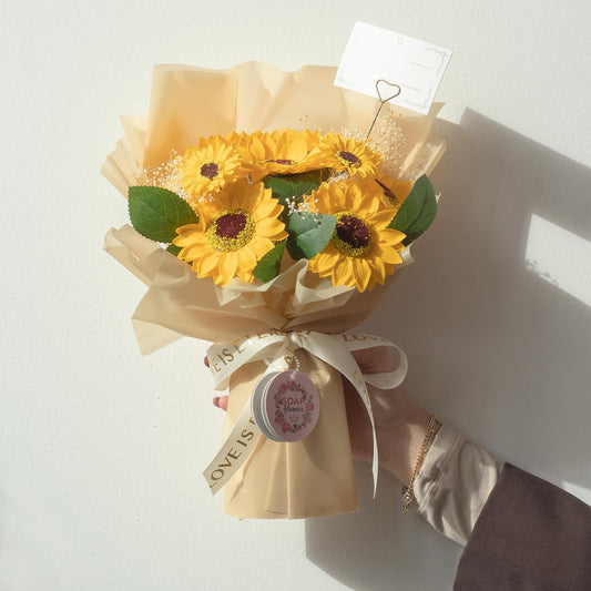 Large vibrant sunflower bouquet crafted from soap petals in golden wrapping with "Love is Eternal" ribbon