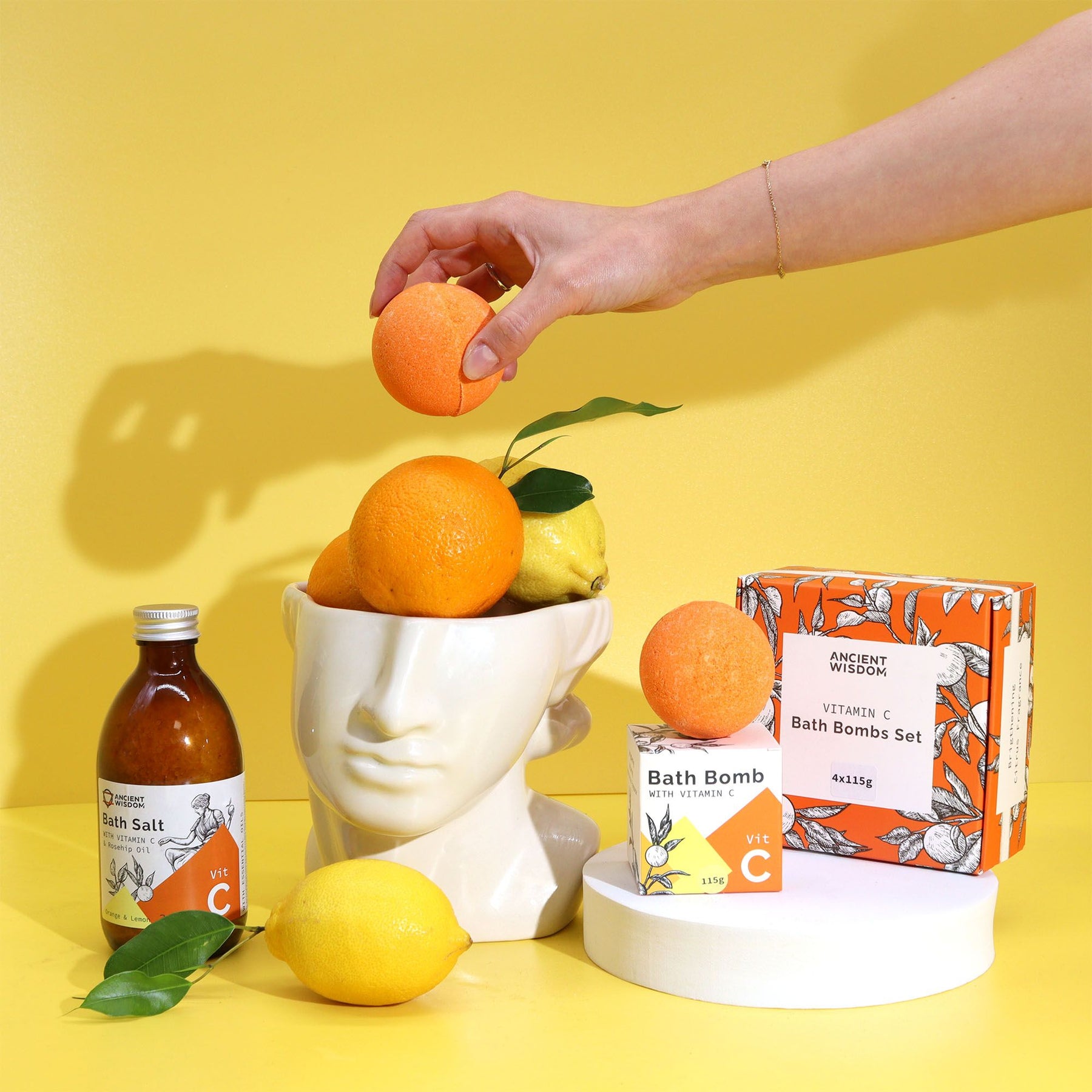 Bath products with oranges and lemons on a yellow background