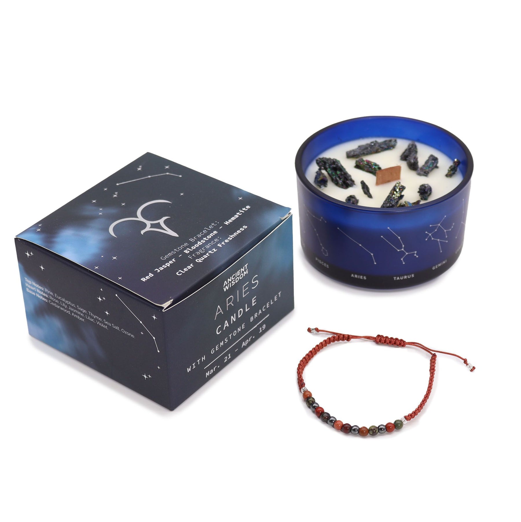 Bold red Aries zodiac candle burning beside matching red jasper, bloodstone & hematite bracelet, styled with ram symbol, pine branches and Aries constellation card
