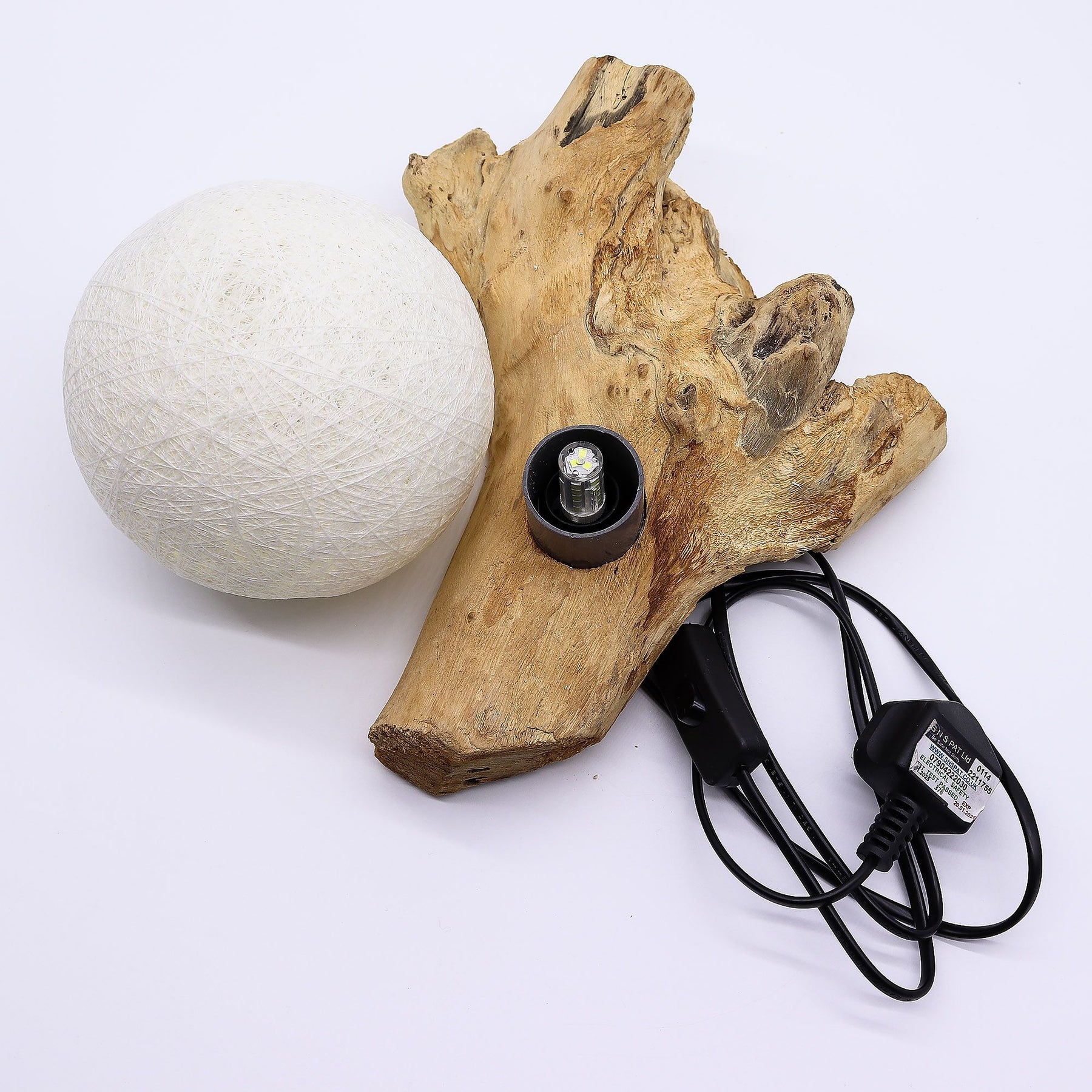 Wooden lamp base with a white spherical lampshade and power cord