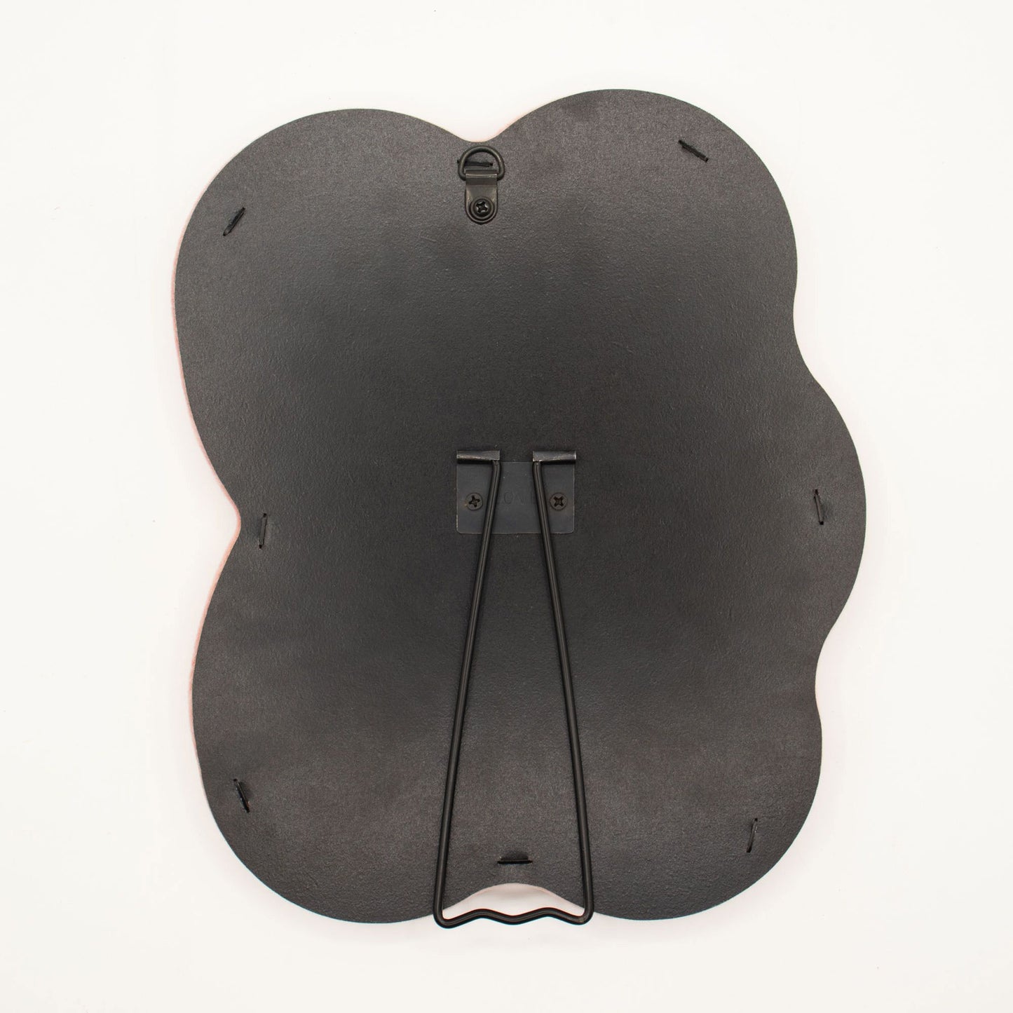Detail of built-in stand on back of mirror for tabletop use, sturdy MDF construction visible