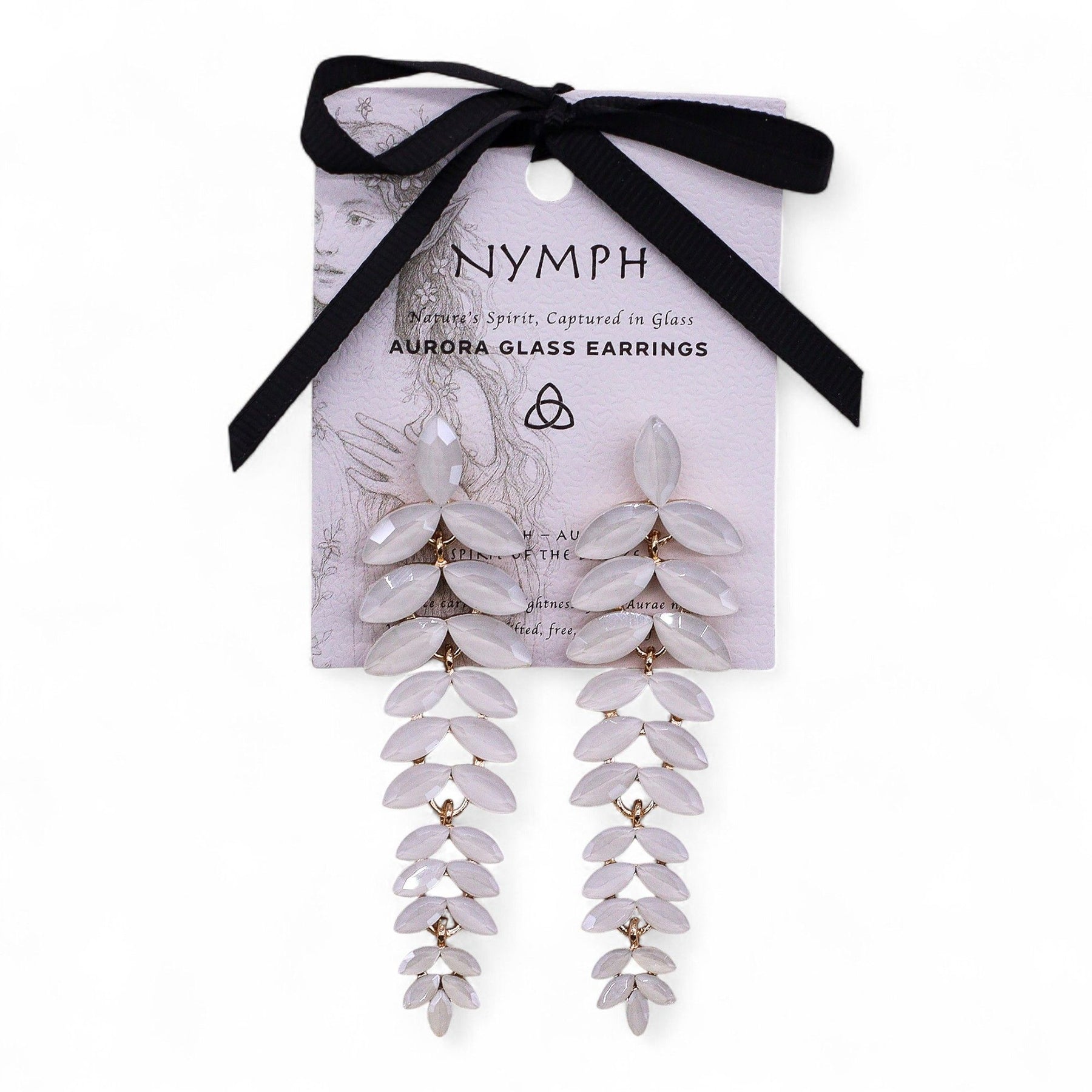 Delicate pearl-white vintage glass long drop earrings swaying gently, catching dawn light against soft white fabric and morning mist