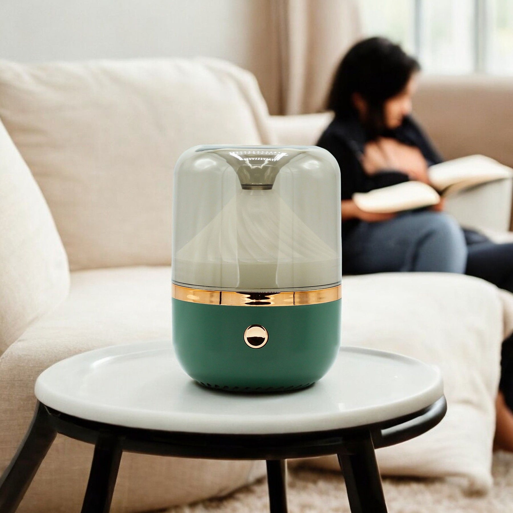 Green and gold humidifier on a small round table