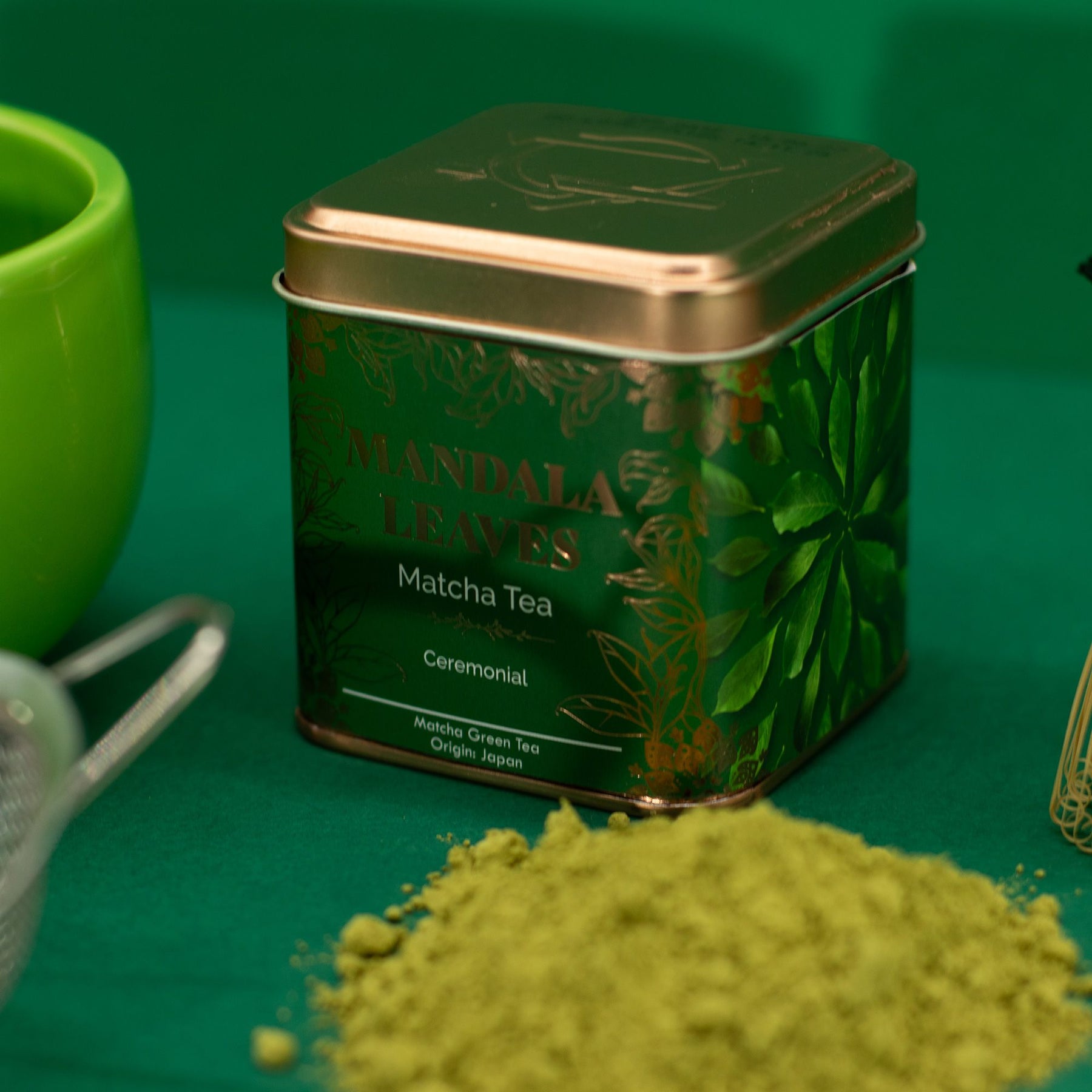 Matcha tea canister with green tea powder on a green background
