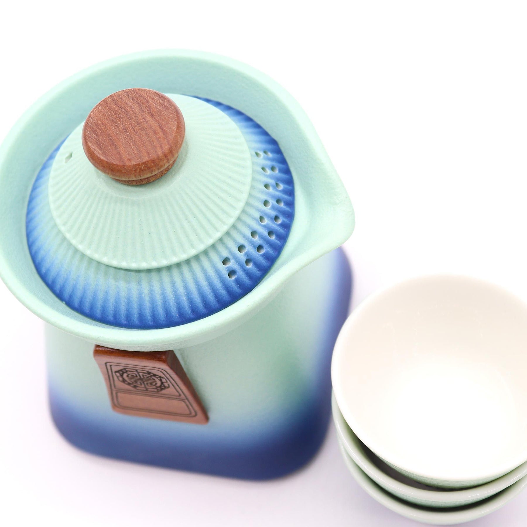 Tea infuser with gradient blue to green design on a white background