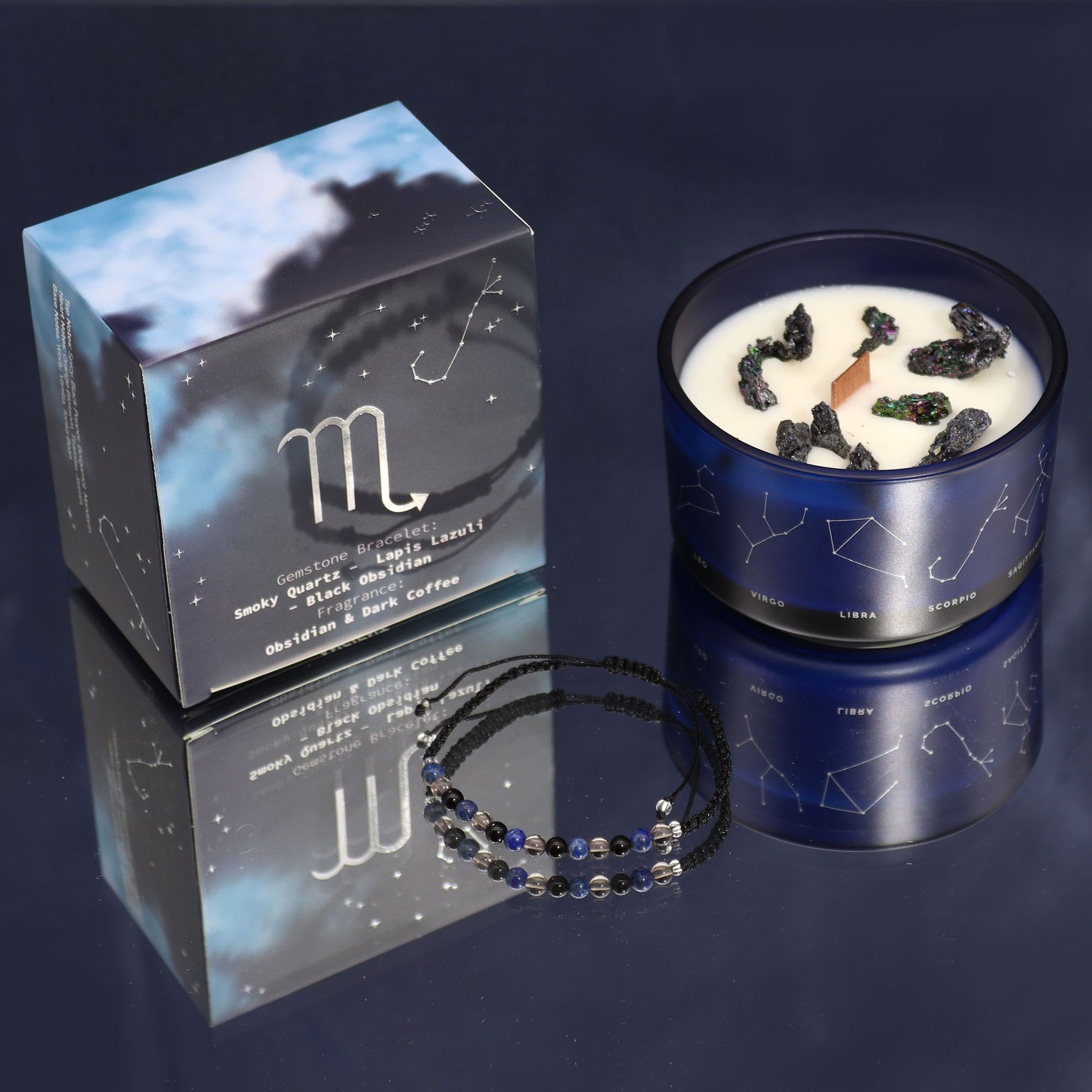 Candle with Scorpio symbol packaging and beaded necklace on a dark background