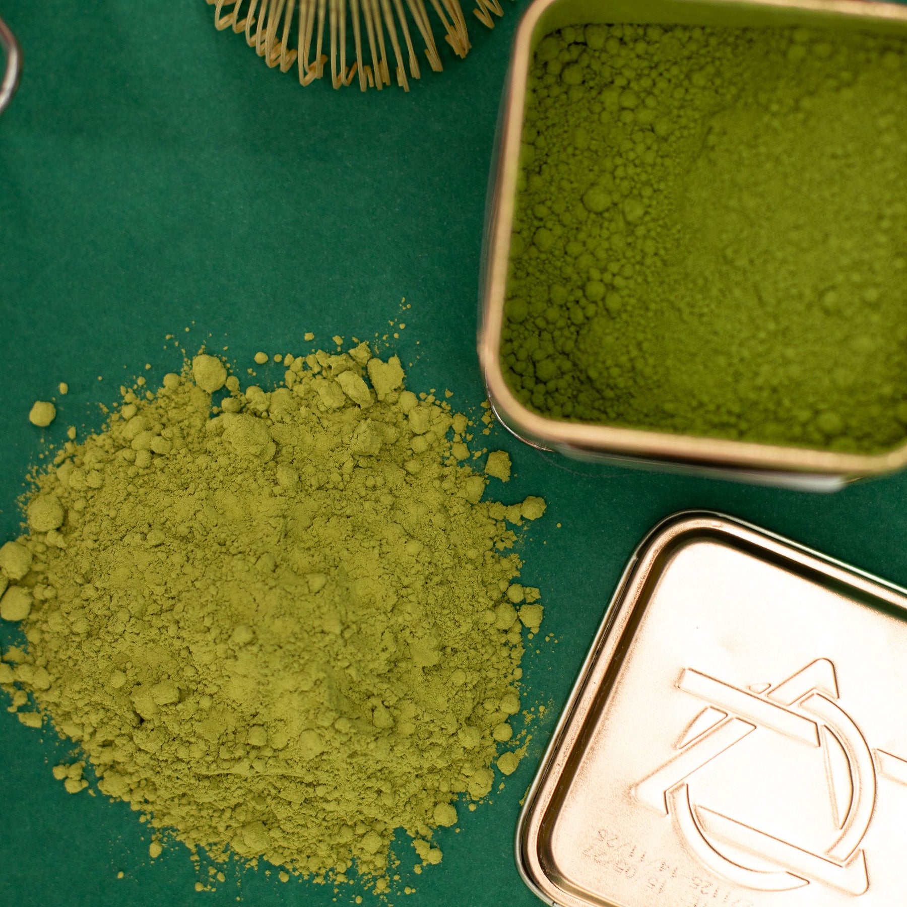 Green tea powder with a metal container on a green background