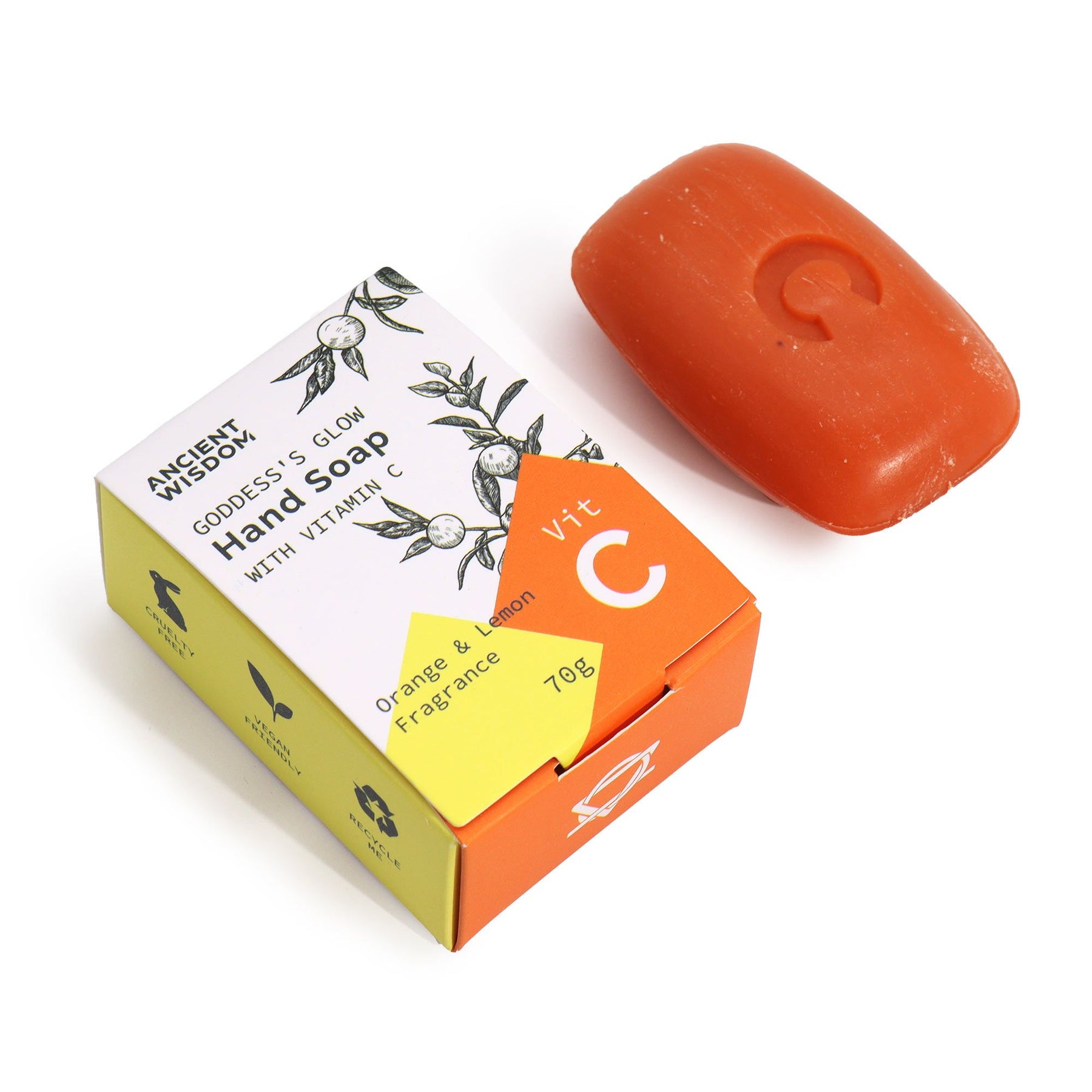 Orange bar of soap with a colorful packaging box on a white background