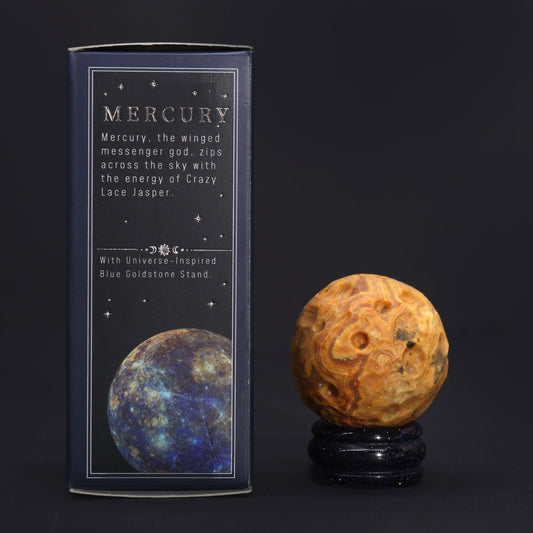 40mm swirling Crazy Lace Jasper Mercury sphere floating on shimmering goldstone ring stand, glowing against starry cosmic background