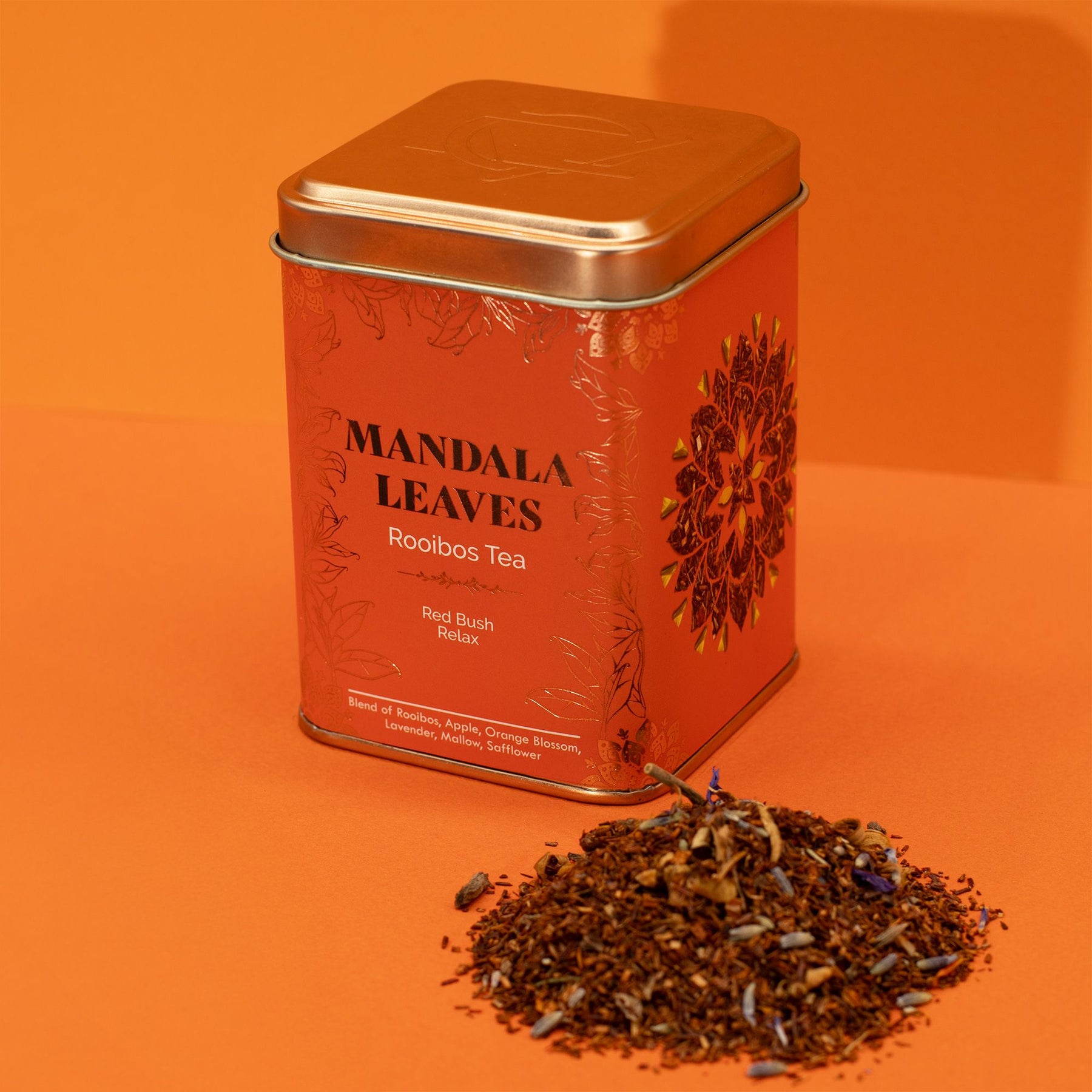 Mandala Leaves Rooibos Tea tin with tea leaves on an orange background