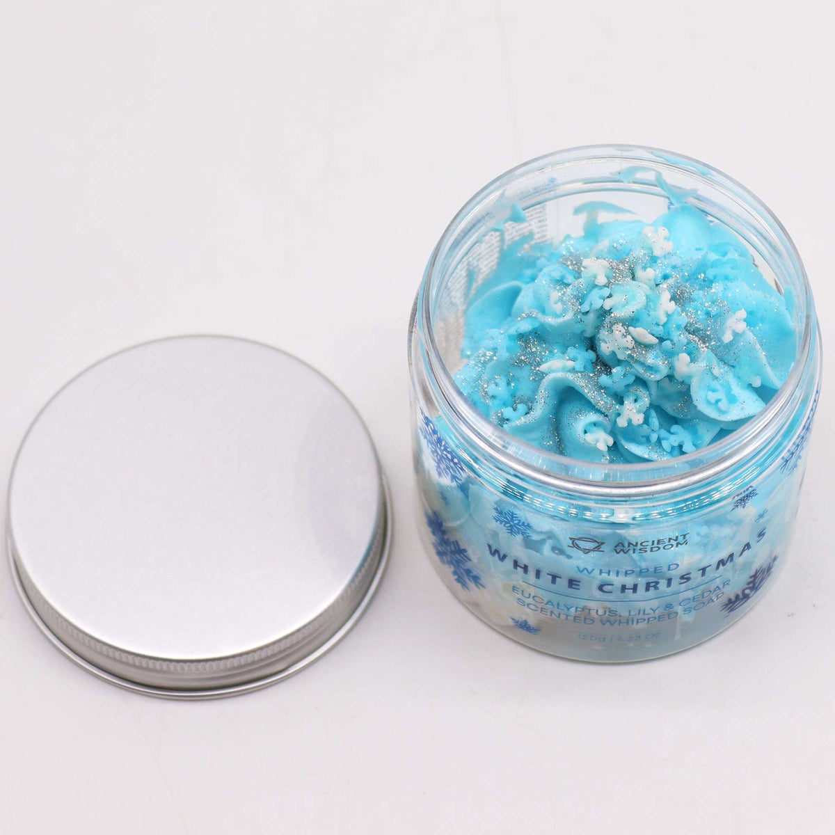 White Christmas Whipped Soap 120g jar topped with biodegradable glitter and delicate sugar snowflakes on festive red background