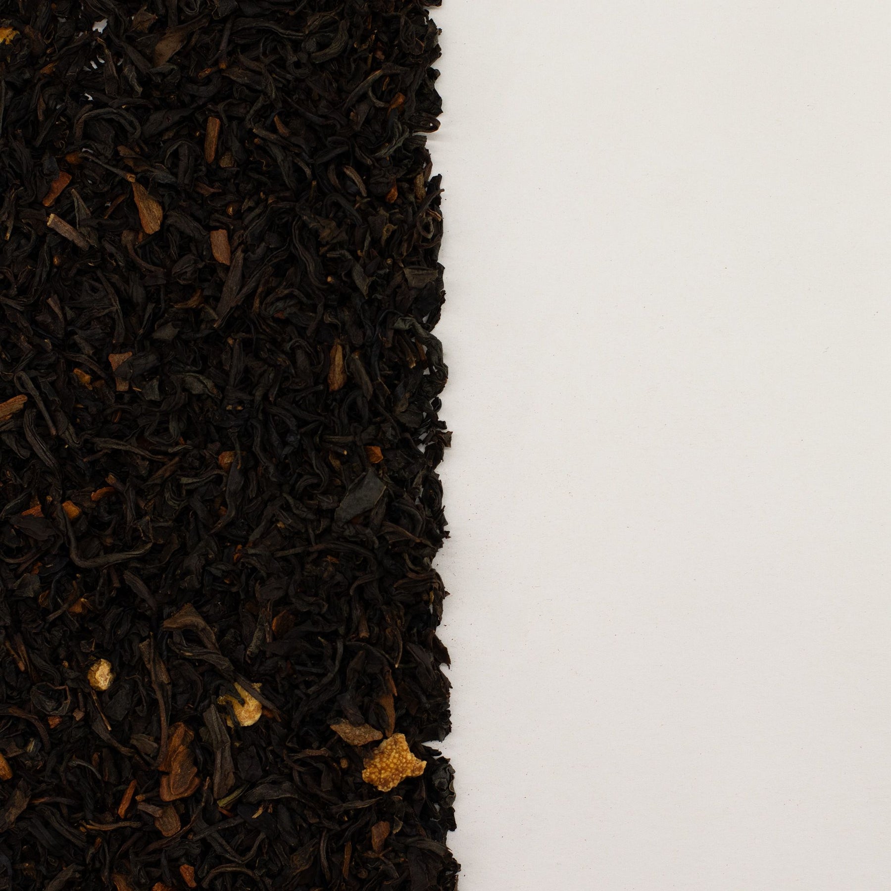 Close-up of black tea leaves on a white background