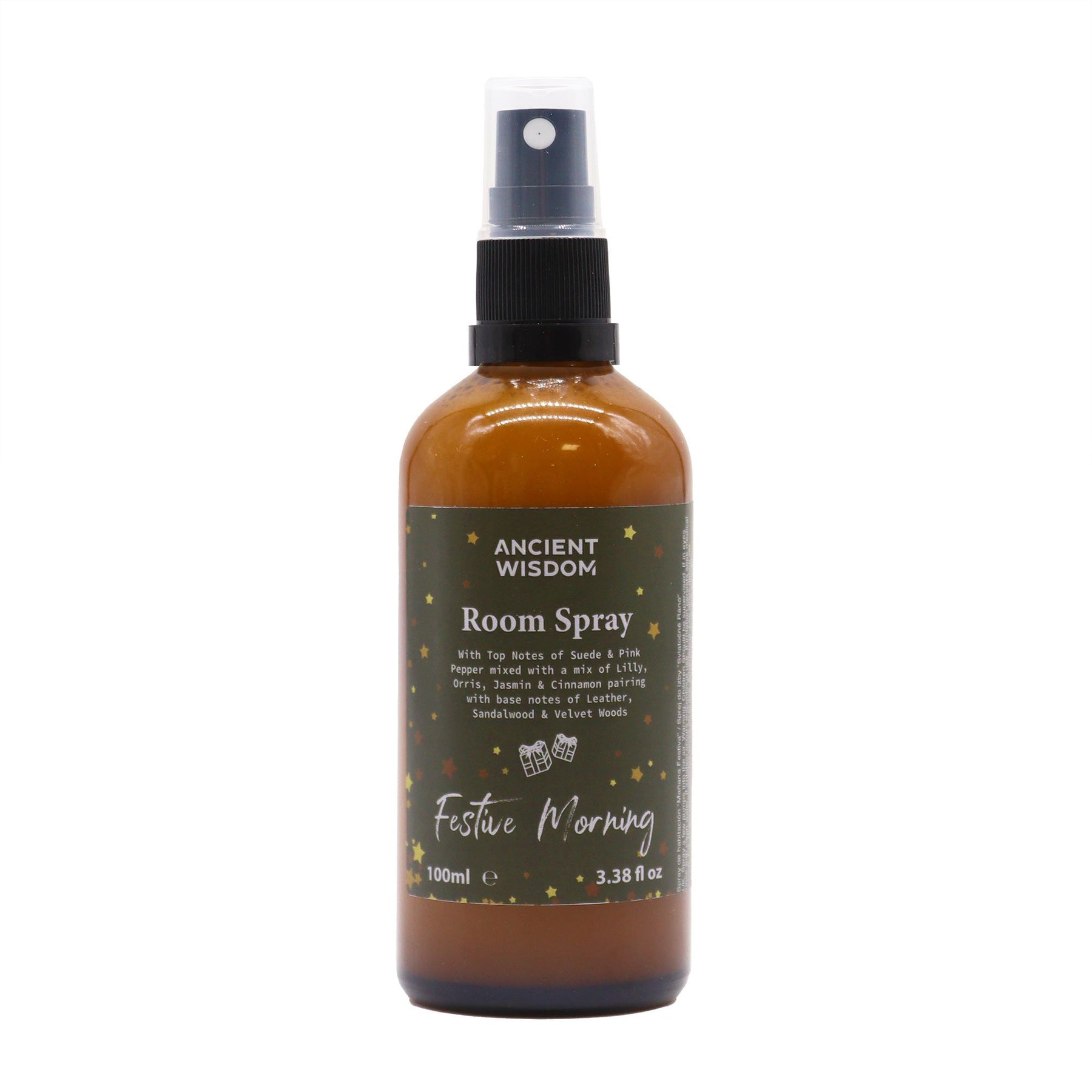 100ml Festive Morning room spray in matte amber bottle with gold sprayer, surrounded by cinnamon sticks, jasmine flowers and velvet ribbon on dark wooden table