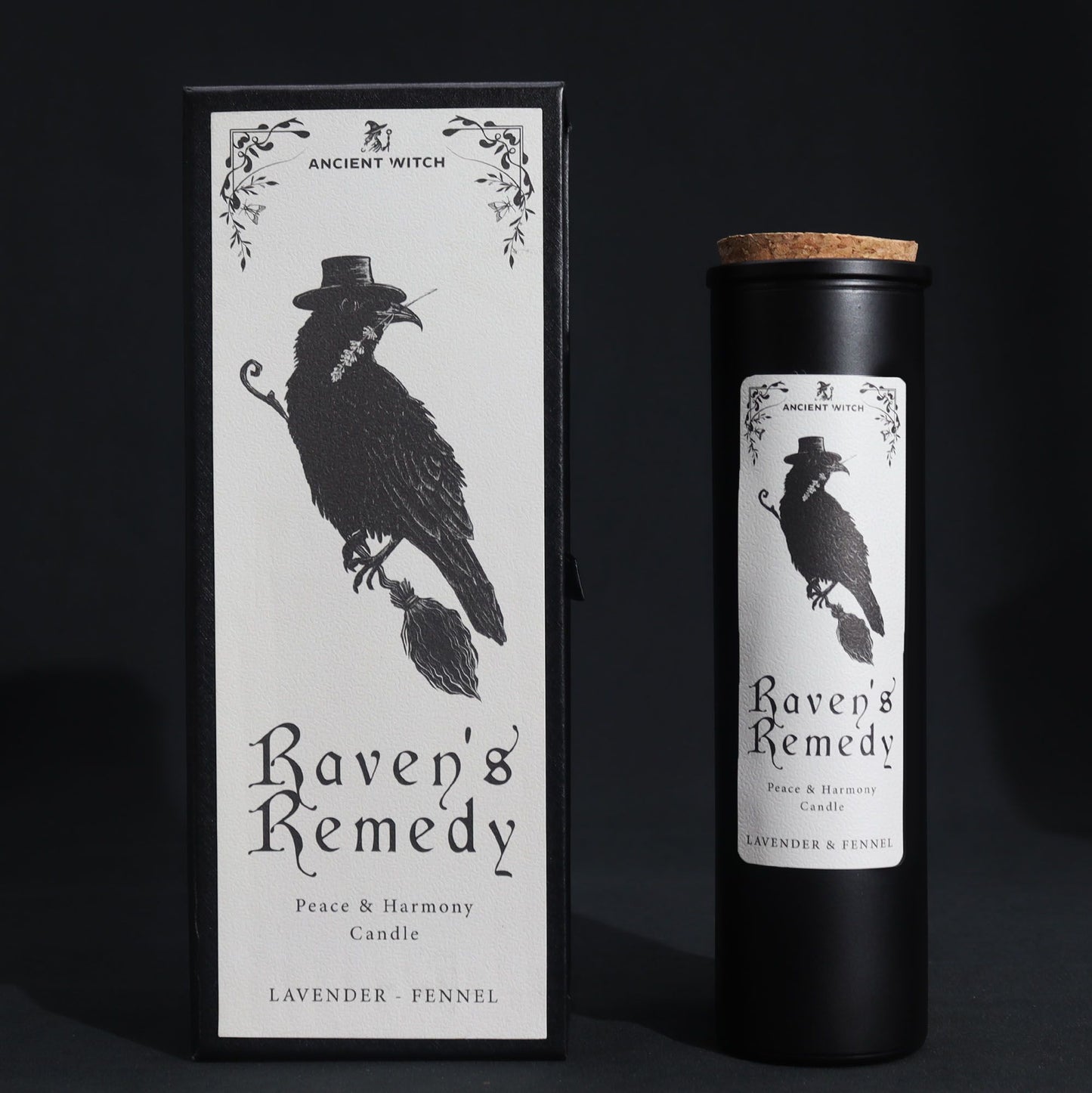 Black matte glass Raven’s Remedy candle burning with purple flame, surrounded by raven feathers, dried lavender, fennel seeds and a spell card on dark velvet