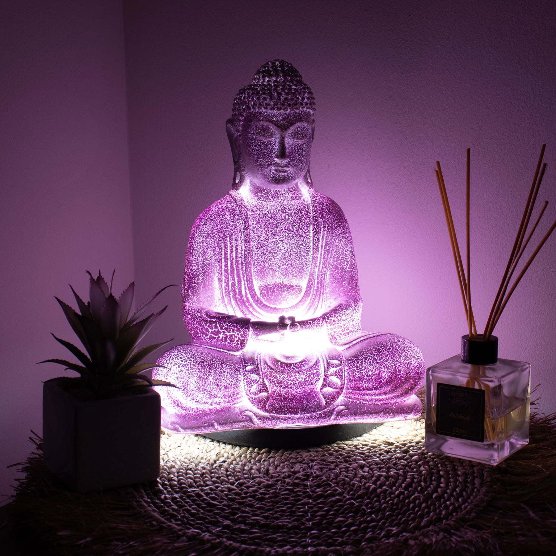 Meditation Buddha Lamp with crackle textured surface on modern oval stand, emitting soft warm ambient glow in a calm living space with subtle lighting