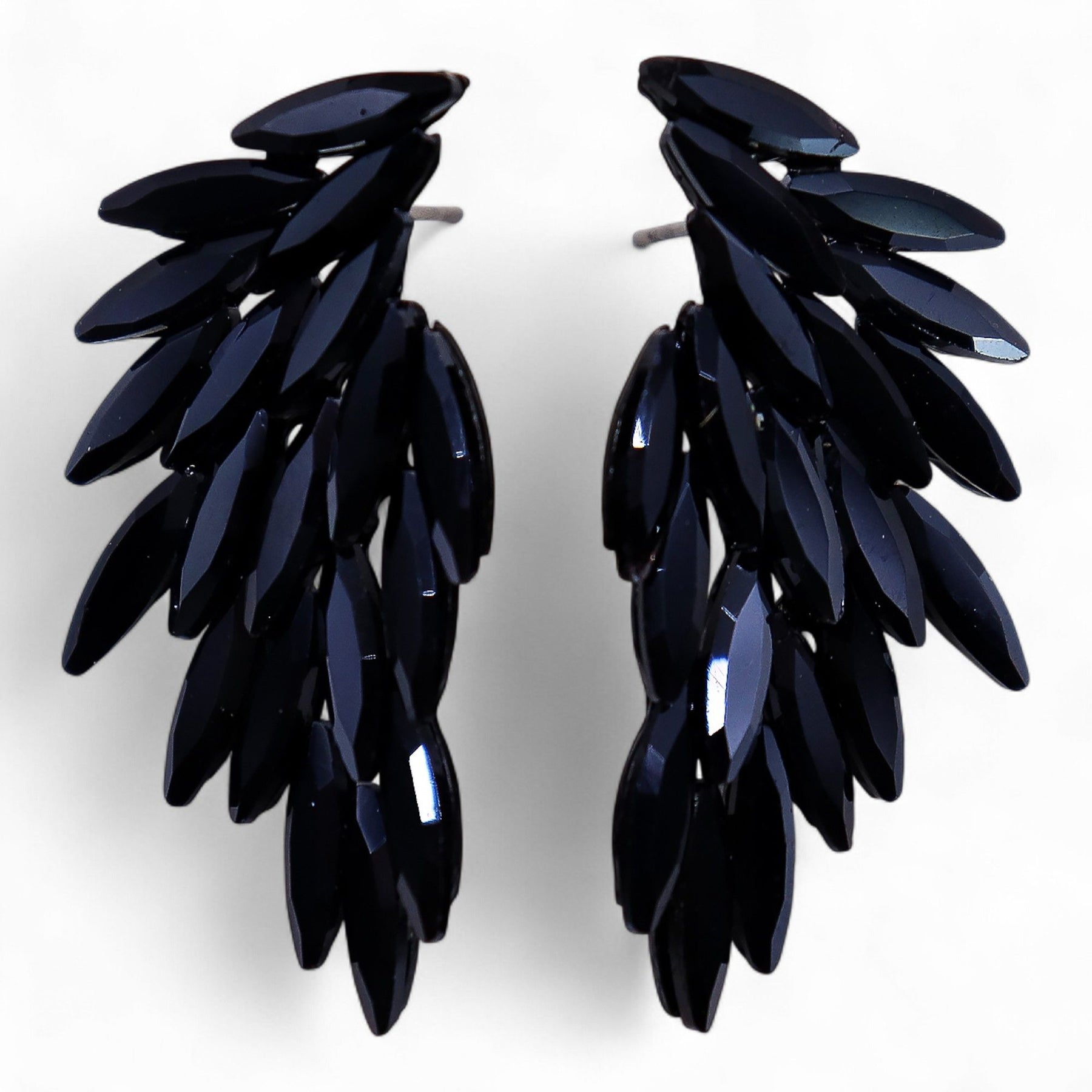 Jet black vintage glass angel wing earrings glowing like embers in darkness