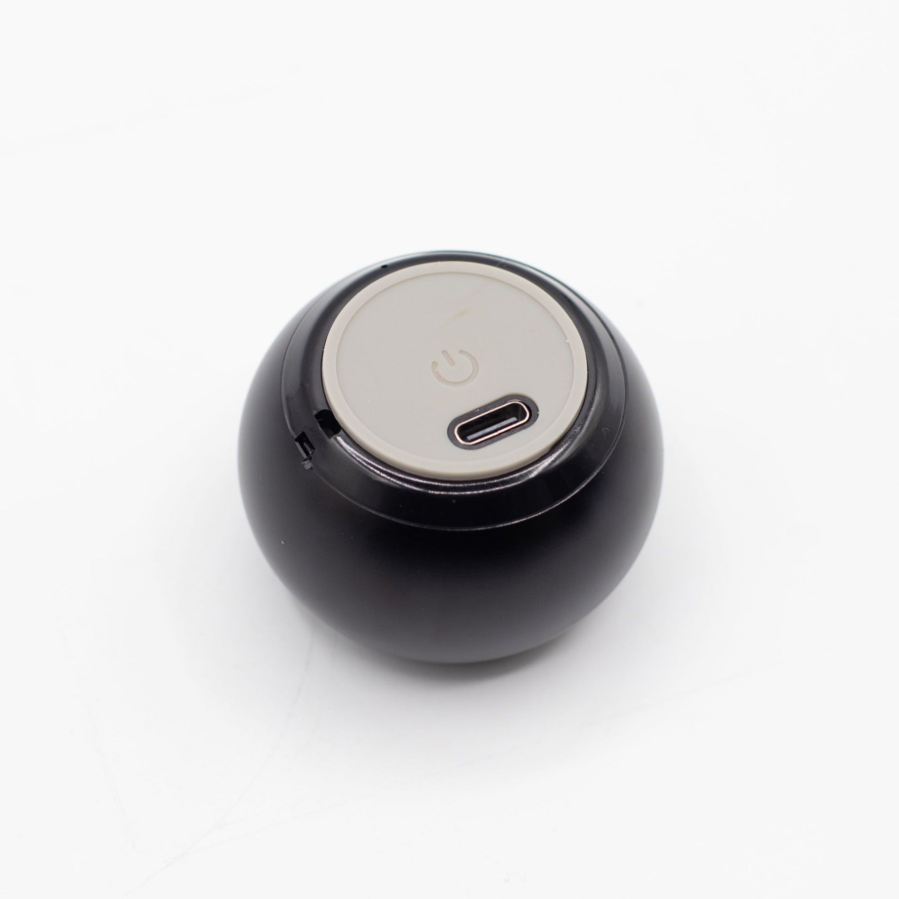 Speaker connected via USB charging cable, 300mAh battery indicator lit, compact size