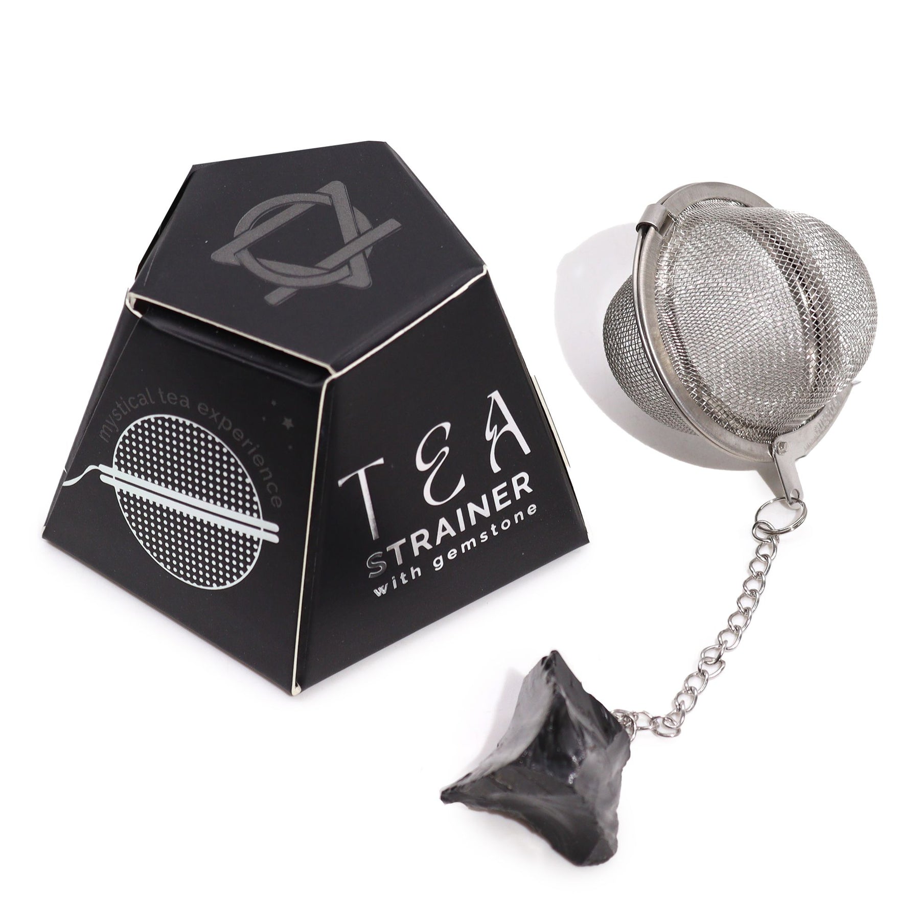 Tea strainer with gemstones in a black geometric packaging on a white background