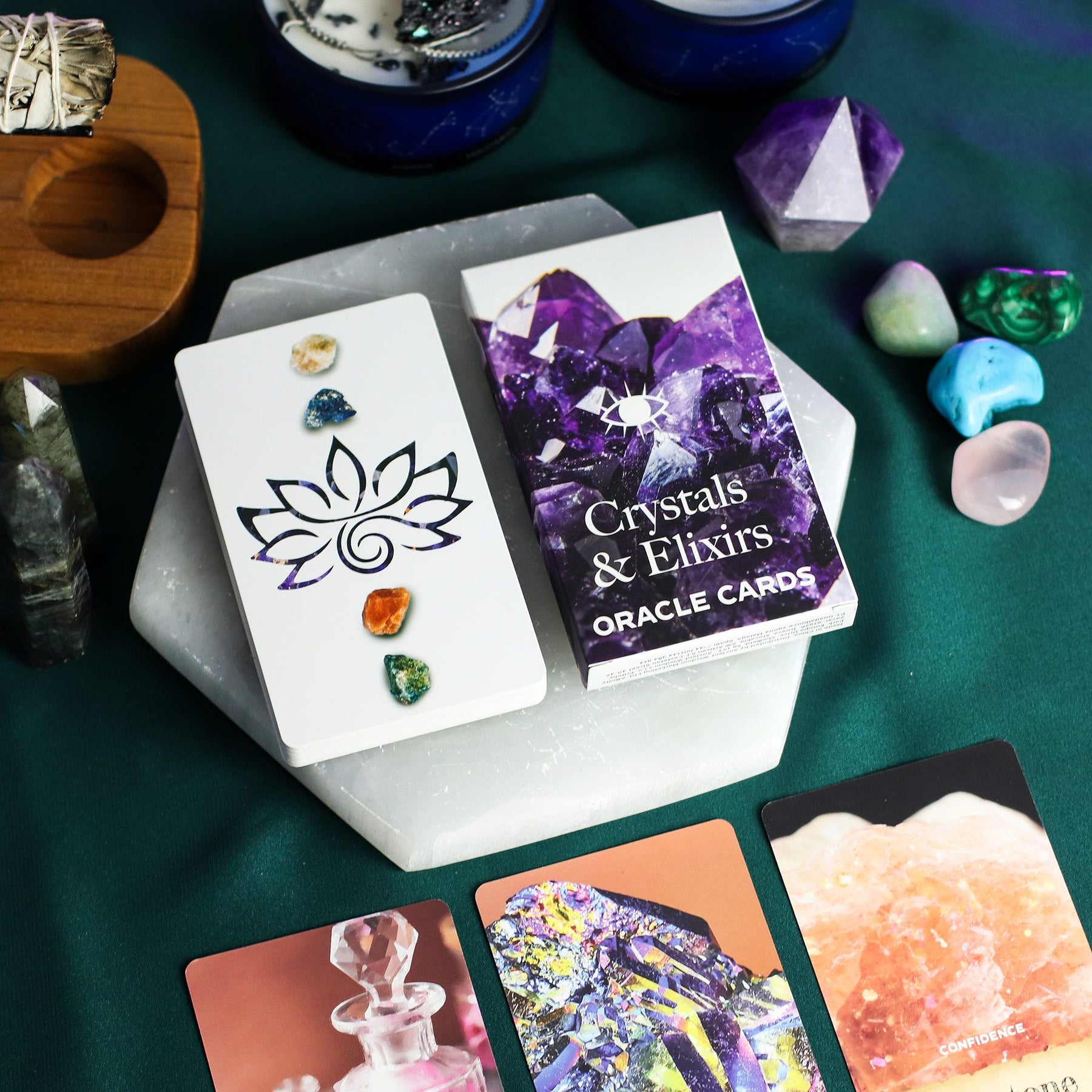 Oracle cards titled 'Crystals & Elixirs' with crystals and gemstones on a green surface