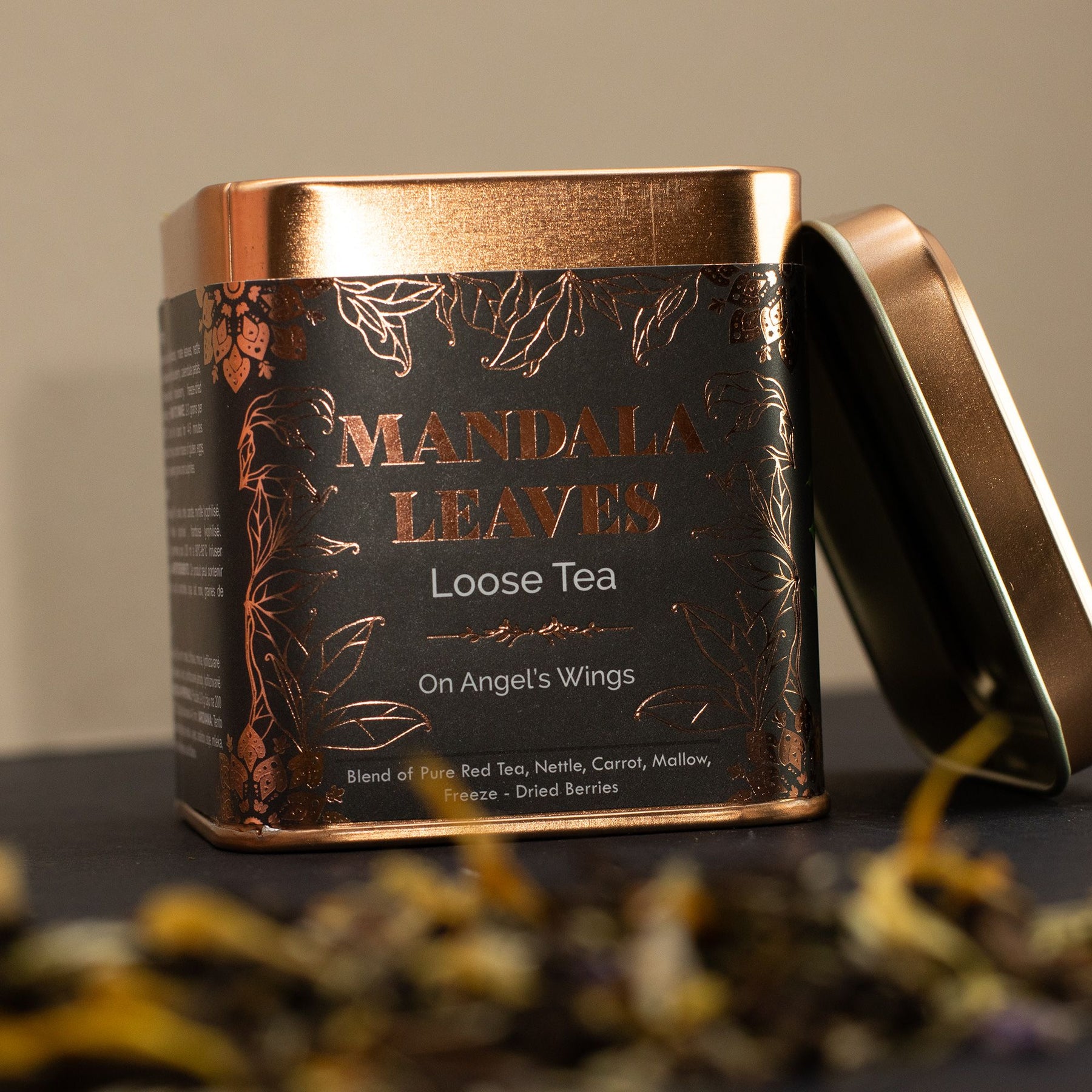 Mandala Leaves loose tea canister with gold lid on a dark surface