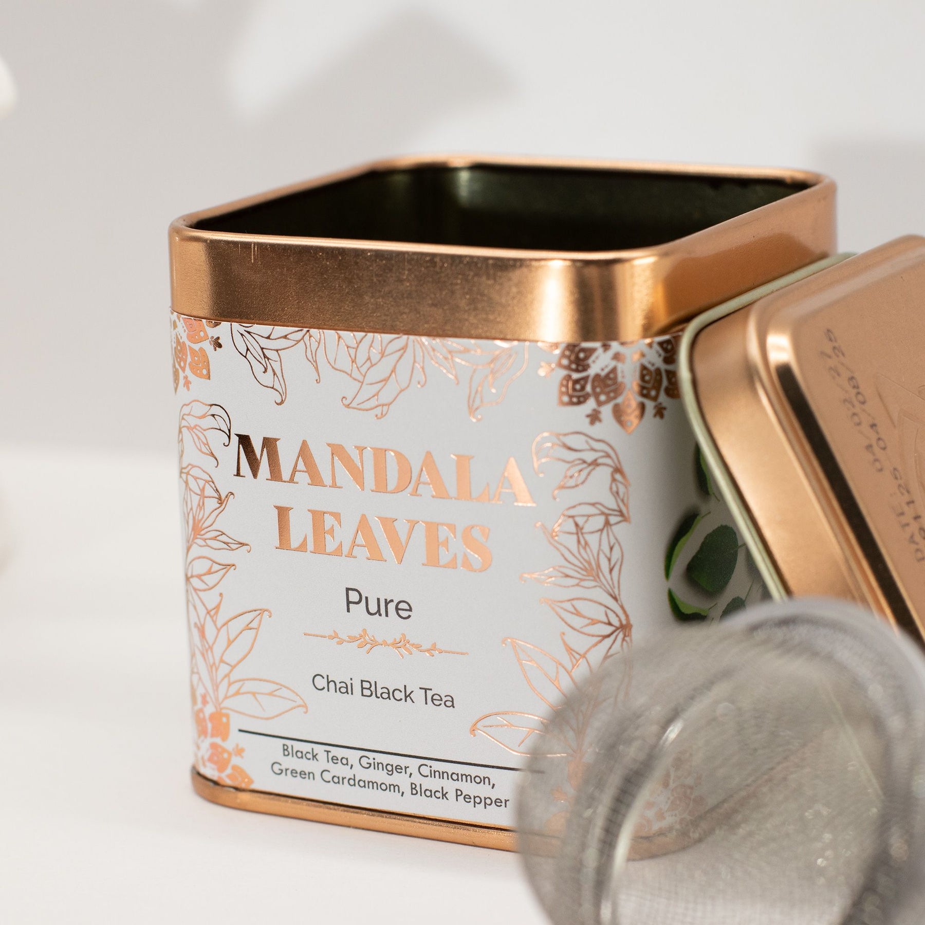 Mandala Leaves tea canister with a gold lid on a white background