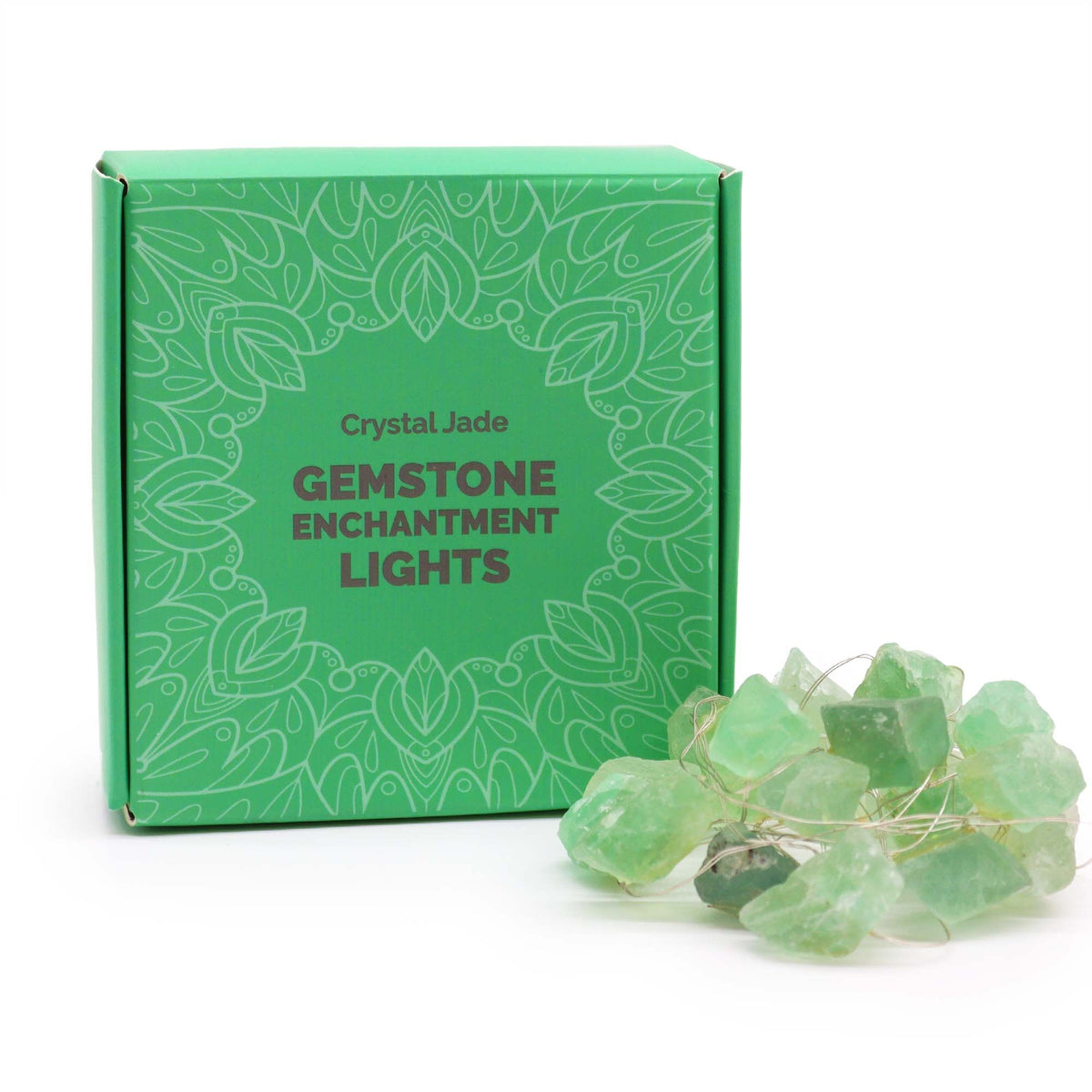 Crystal jade fairy lights glowing soft green in glass bowl on wooden desk with bamboo, coins and prosperity crystals in calming setting