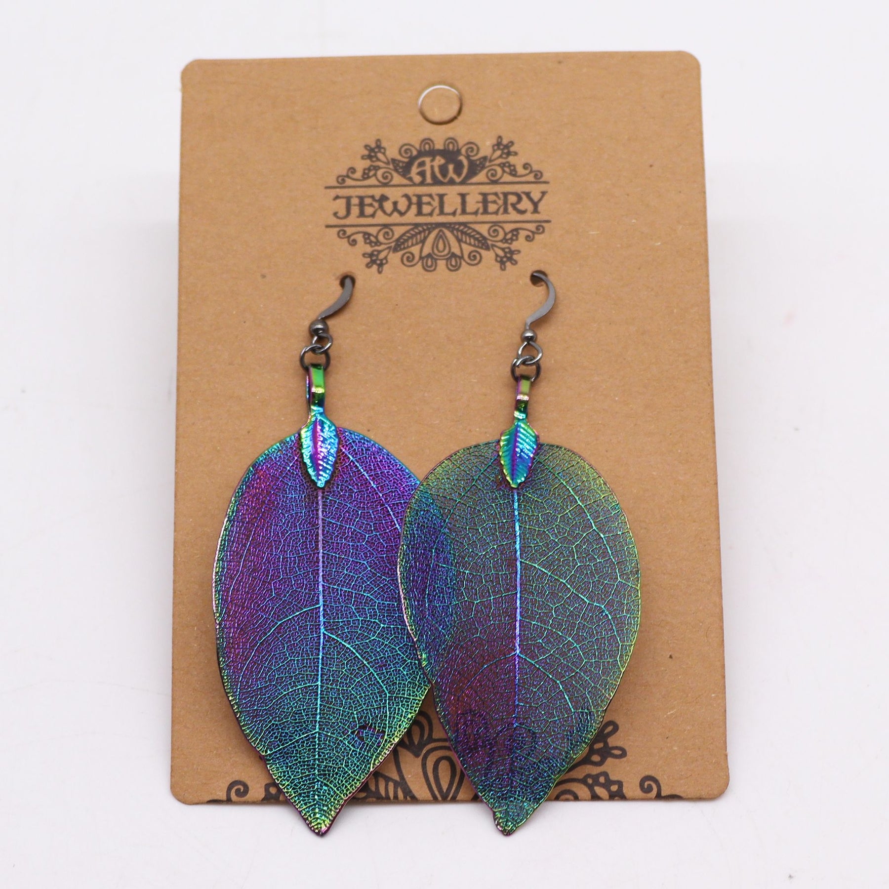 Rainbow-multicolour real-leaf earrings catching prismatic light on a 'Jewellery' branded card