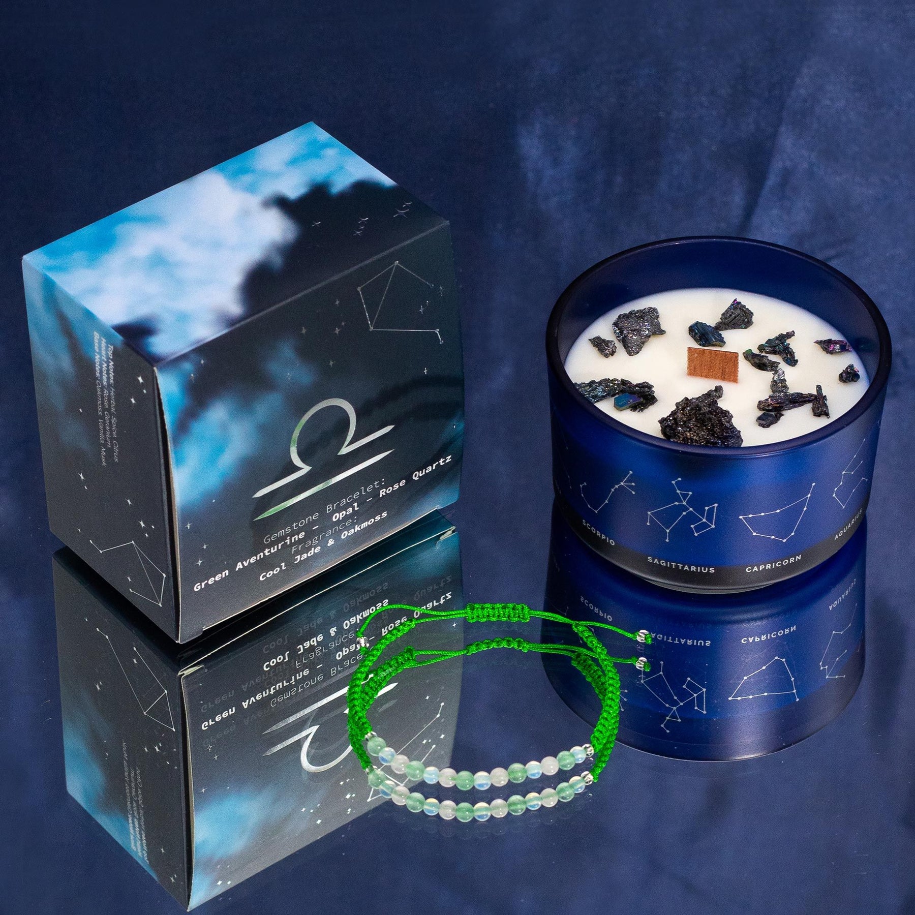 Soft jade-green Libra zodiac candle burning beside delicate rose quartz, opal & aventurine bracelet, styled with scales and Libra constellation card