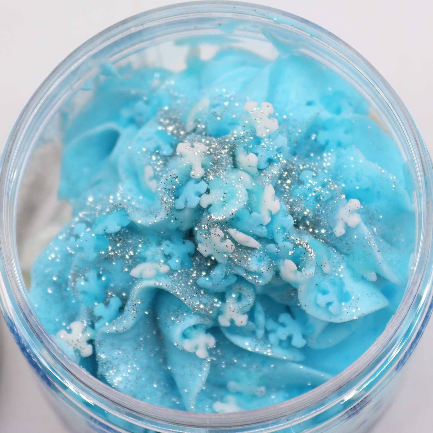 White Christmas Whipped Soap 120g jar topped with biodegradable glitter and delicate sugar snowflakes on festive red background