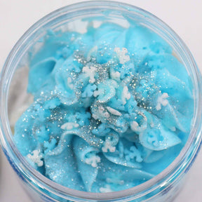 White Christmas Whipped Soap 120g jar topped with biodegradable glitter and delicate sugar snowflakes on festive red background