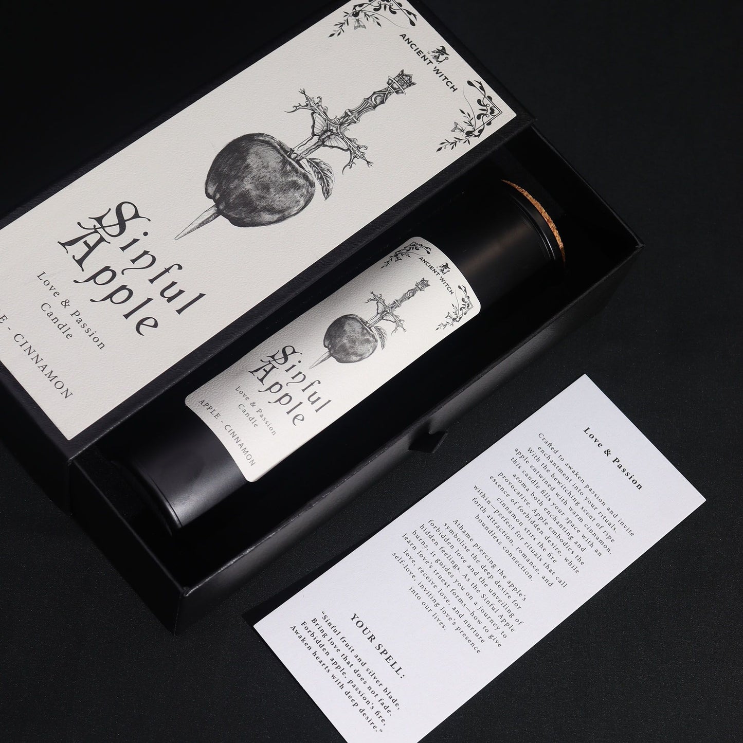 Candle set with packaging and a card on a black background