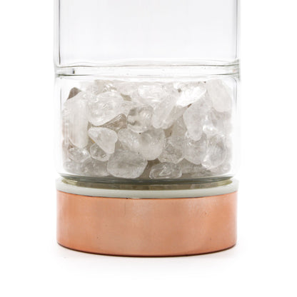 Rose gold rock quartz crystal tea infuser bottle with removable bottom chamber full of clear quartz points, neoprene sleeve
