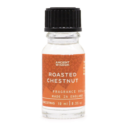 10ml amber glass bottle of Roasted Chestnut fragrance oil with chestnuts and glowing fireplace in cosy winter background