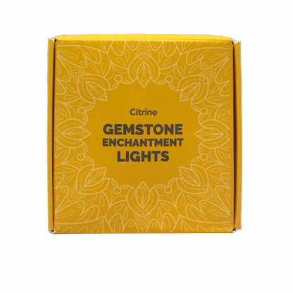 Yellow box with 'Citrine Gemstone Enchantment Lights' text and decorative patterns on a white background