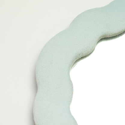 Close-up of Cloud Blue velvet texture on padded frame, showing plush finish and gentle cloud-inspired squiggly edge detail