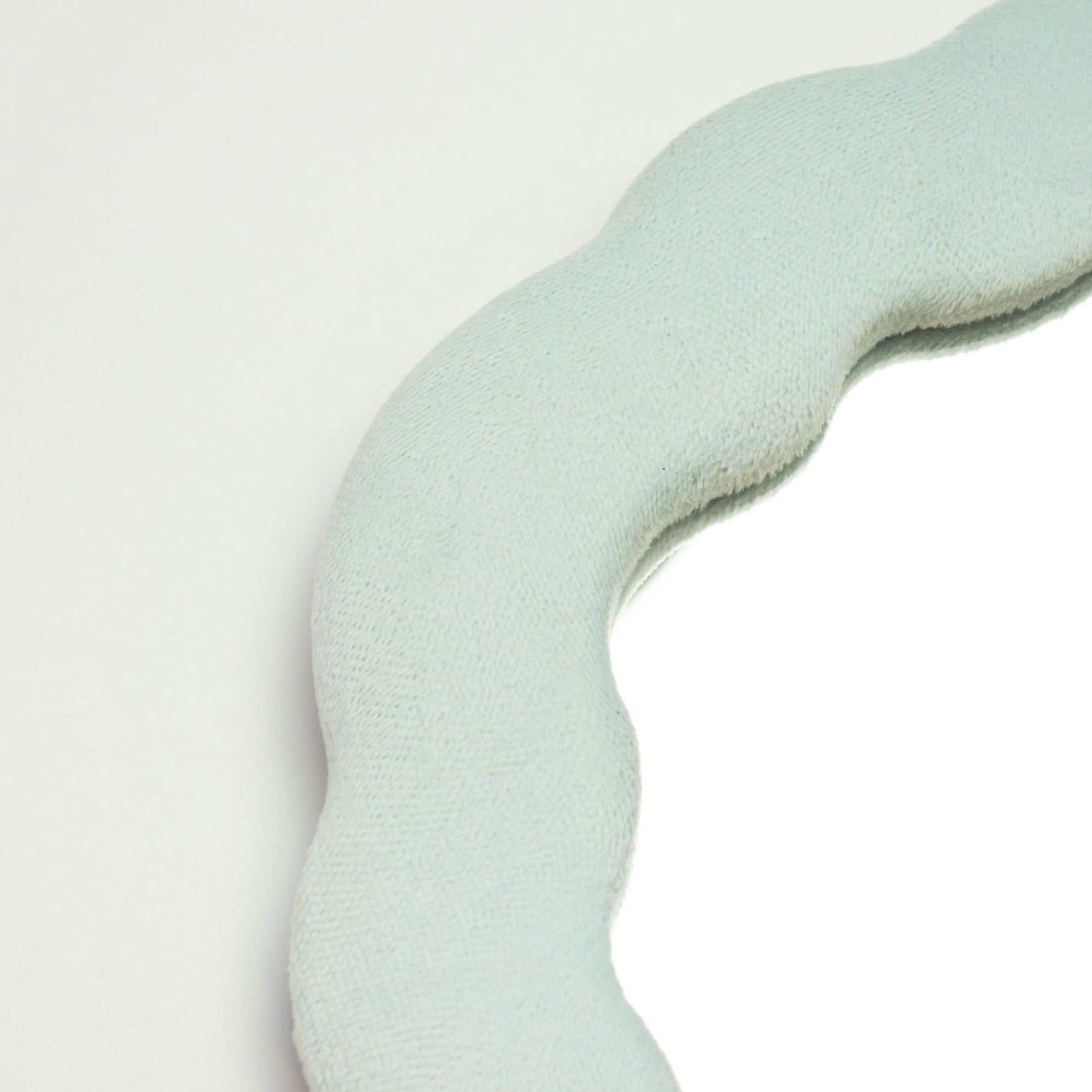 Close-up of Cloud Blue velvet texture on padded frame, showing plush finish and gentle cloud-inspired squiggly edge detail