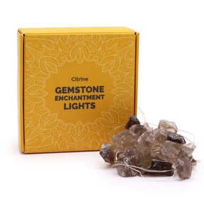 Citrine Gemstone Enchantment Lights with warm golden-yellow glowing bulbs on 227cm string, draped decoratively around crystals and plants, creating uplifting ambient light