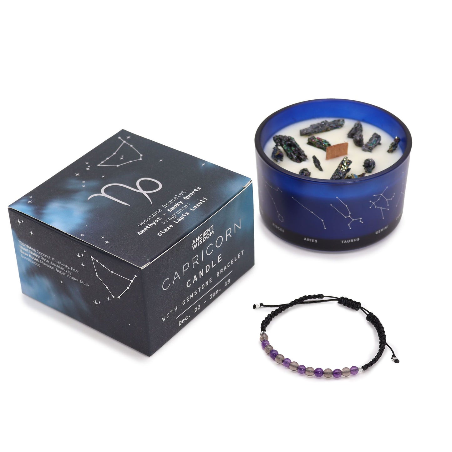 Navy & gold Capricorn zodiac candle burning beside matching amethyst & smoky quartz bracelet, styled with Capricorn constellation card and mountain crystals