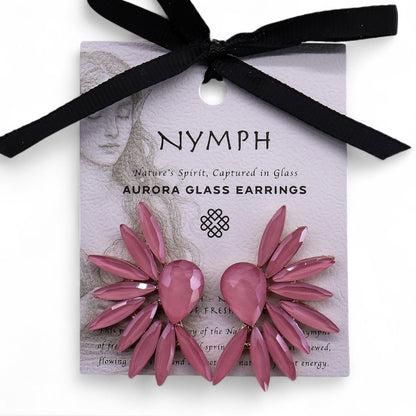 Soft pink vintage glass angel wing earrings catching gentle light, styled with rose petals and crystal-clear water droplets