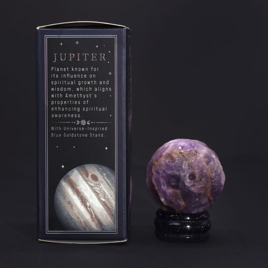 Rich purple 40mm Amethyst Jupiter sphere floating on glittering goldstone ring stand, regal cosmic background with soft golden light