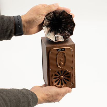 retro gramophone Bluetooth speaker held by a person against a white background