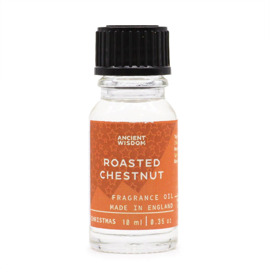 10ml amber glass bottle of Roasted Chestnut fragrance oil with chestnuts and glowing fireplace in cosy winter background