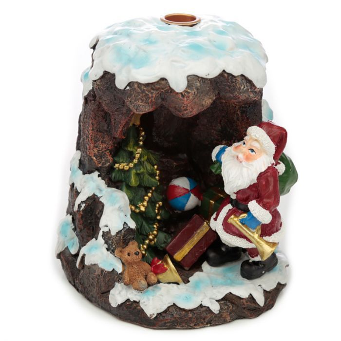 Santa’s Grotto backflow incense burner with glowing LED, smoke flowing down like waterfall, surrounded by cones and Christmas lights
