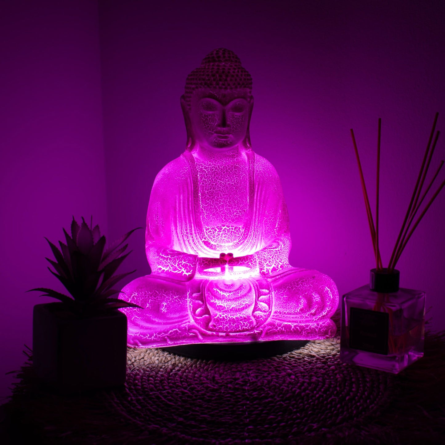 Meditation Buddha Lamp with crackle textured surface on modern oval stand, emitting soft warm ambient glow in a calm living space with subtle lighting